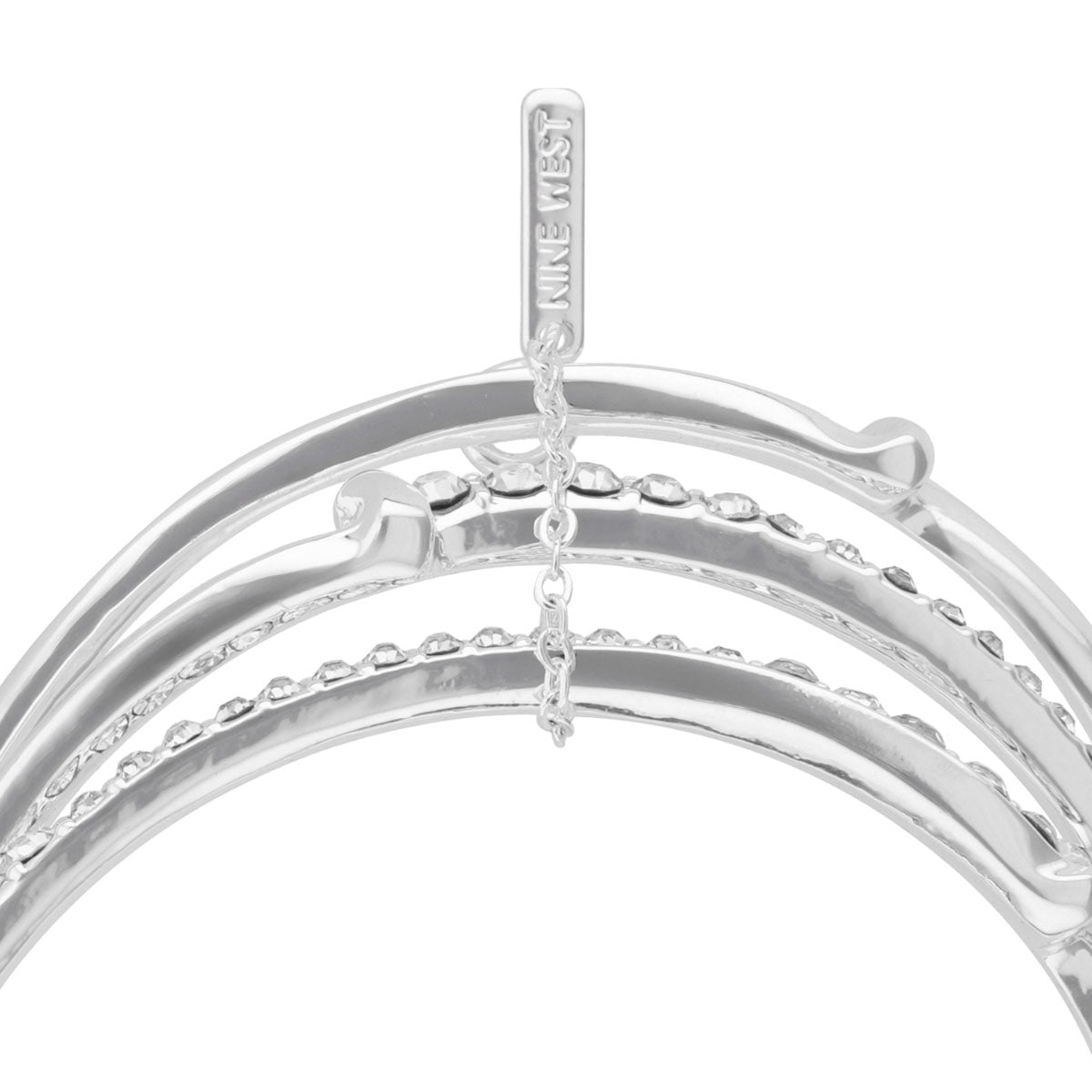 PULSERA NINE WEST TWISTED CRYSTAL STONES PLATEADO